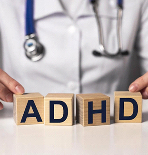 doctor sitting with adhd letters in front of him