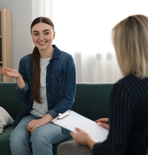 Smiling patient explaining something during psychotherapy session